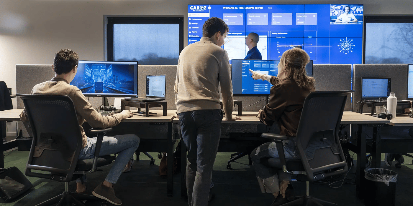 Caroz Control Tower team monitoring shipments on large screens.